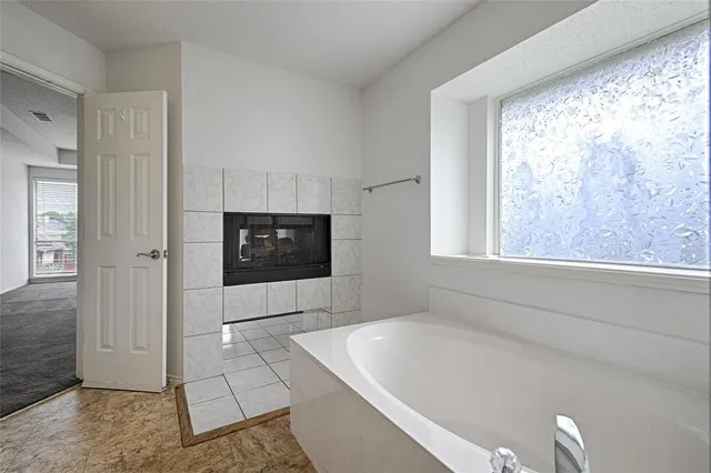 a living room with a large window and a flat screen tv