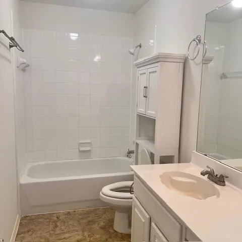 a bathroom with a sink a toilet and a bathtub