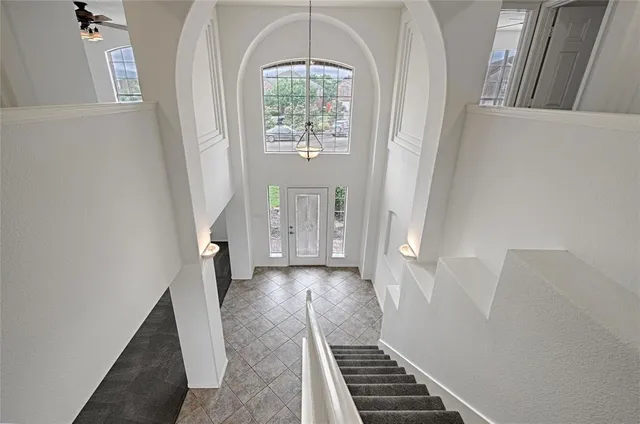 a view of a hallway view with wooden floor and staircase