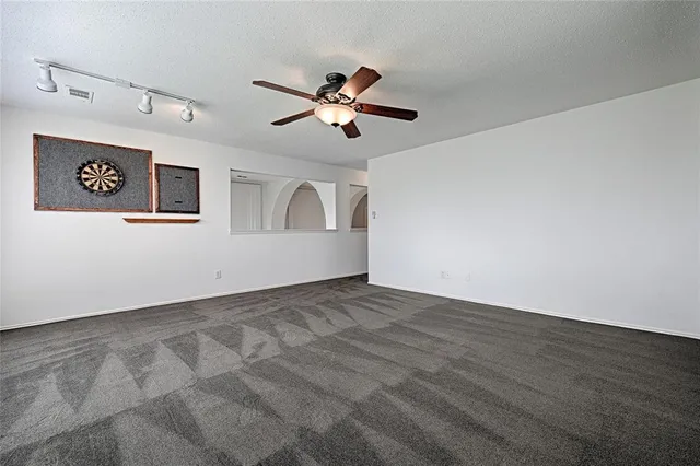 a view of a ceiling fan and hardwood floor