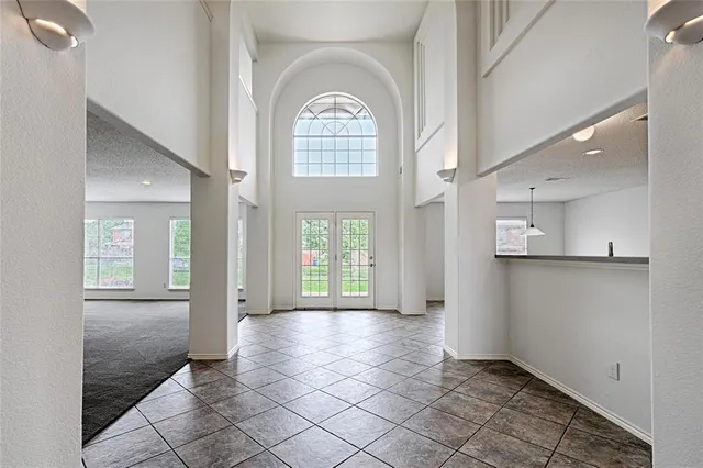 a view of a hallway with wooden floor and a living room