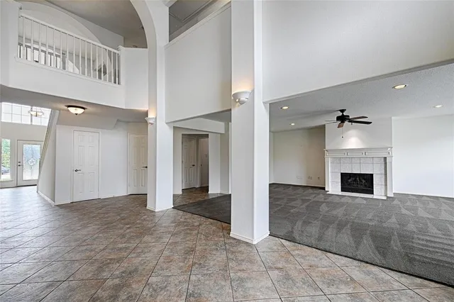 a view of an empty room and fire place