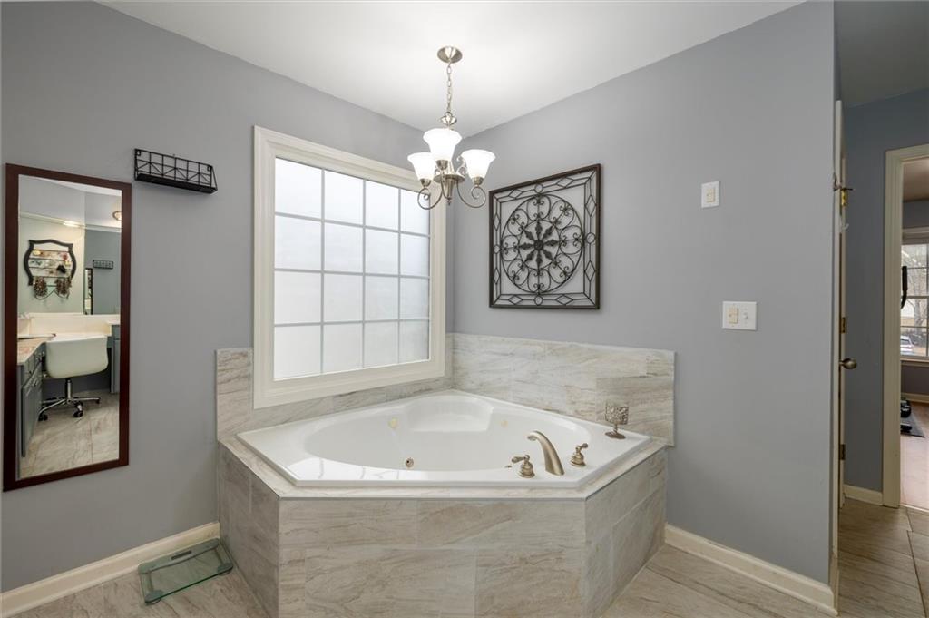 2016 Portage Point Southeast Lawrenceville, GA 30045 - Photo 12 of 44 a bath tub sitting in a bathroom next to a window