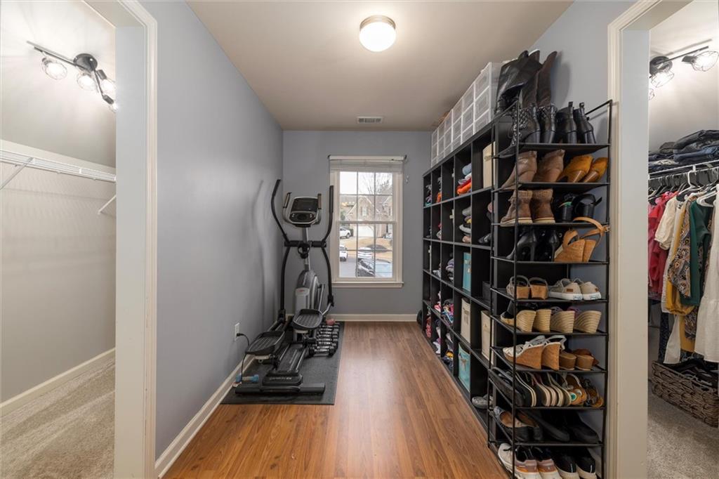 2016 Portage Point Southeast Lawrenceville, GA 30045 - Photo 13 of 44 a view of walk in closet with clothes and shoes