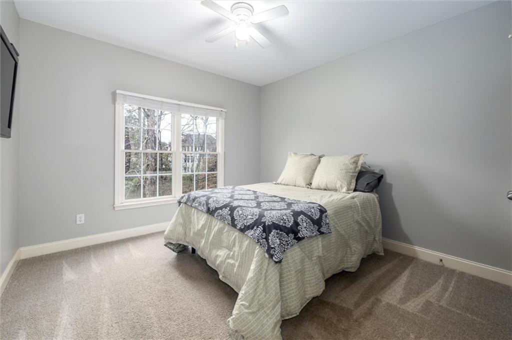 2016 Portage Point Southeast Lawrenceville, GA 30045 - Photo 18 of 44 a bed sitting in a spacious bedroom next to a window