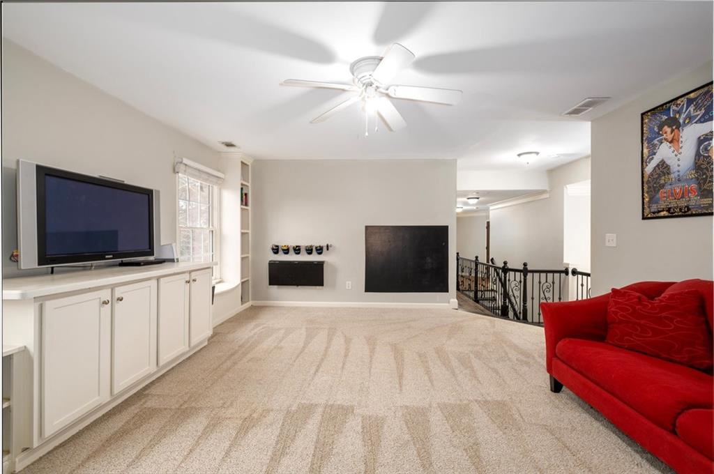 2016 Portage Point Southeast Lawrenceville, GA 30045 - Photo 22 of 44 a living room with furniture and a flat screen tv