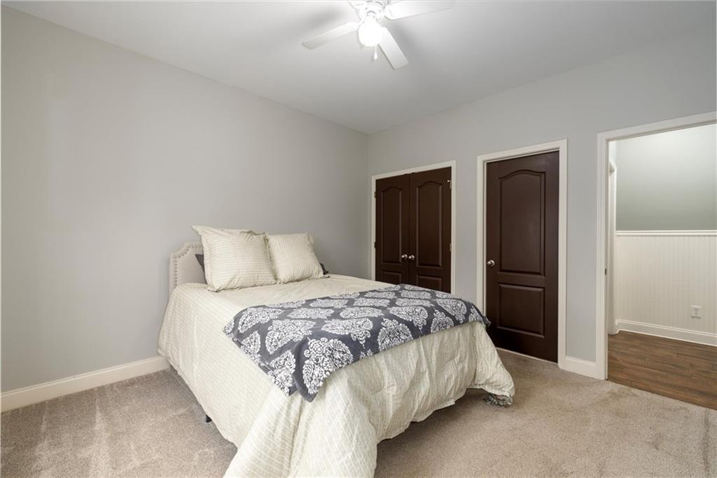 2016 Portage Point Southeast Lawrenceville, GA 30045 - Photo 24 of 44 a bedroom with a bed and a chandelier
