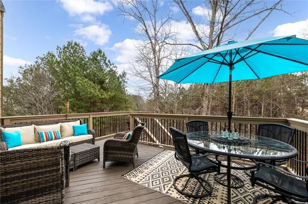 a view of a balcony with wooden floor and fence