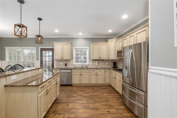 a kitchen with a sink refrigerator and microwave
