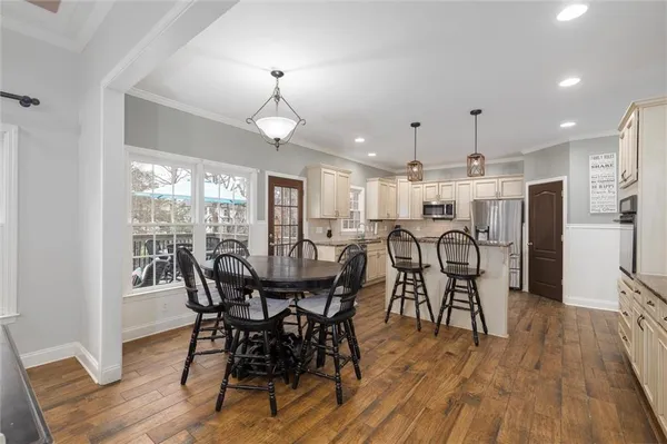 a view of a dining room with furniture and wooden floor