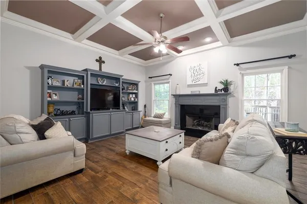a bedroom with a bed a chandelier and a flat screen television