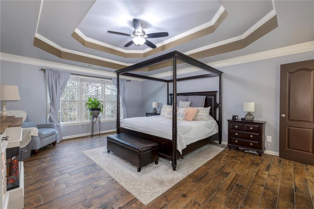 2016 Portage Point Southeast Lawrenceville, GA 30045 - Photo 9 of 44 a bedroom with a bed a chandelier and a flat screen television