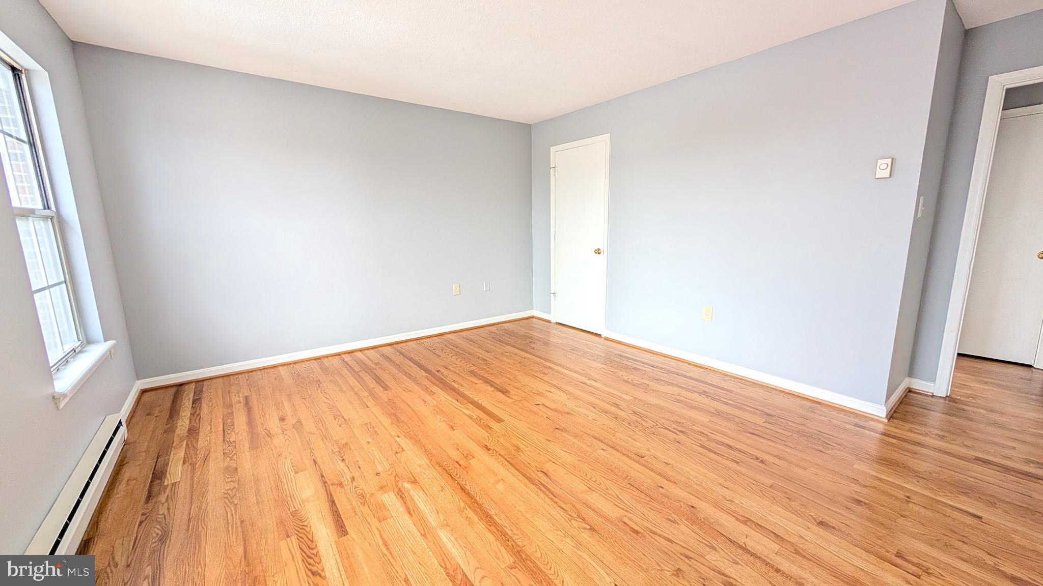 354 Valley Mill Road Winchester, VA 22602 - Photo 14 of 34 an empty room with wooden floor and windows