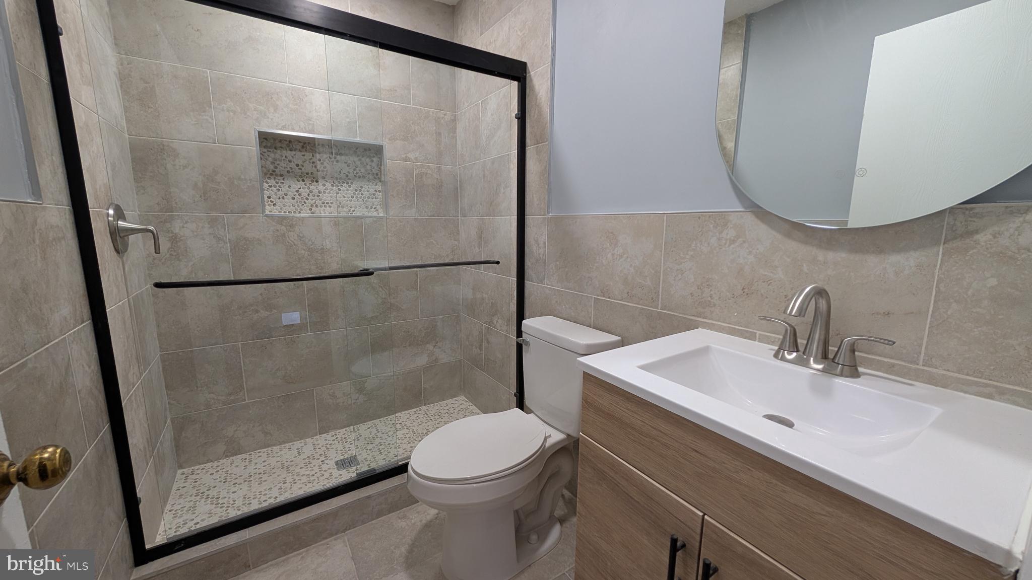 354 Valley Mill Road Winchester, VA 22602 - Photo 26 of 34 a bathroom with a sink a mirror and a shower
