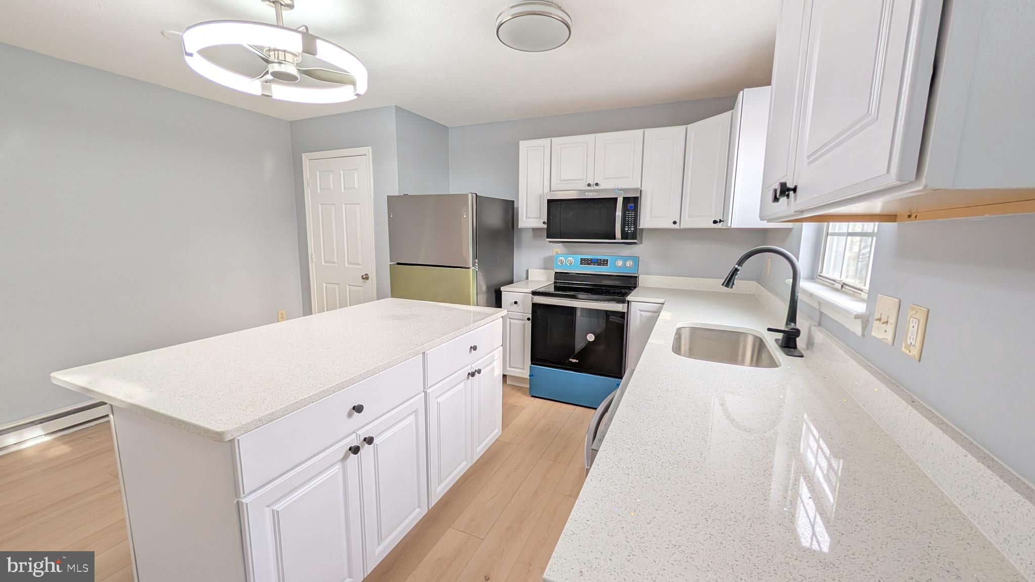 354 Valley Mill Road Winchester, VA 22602 - Photo 5 of 34 a kitchen with stainless steel appliances a sink a stove a refrigerator cabinets and a window