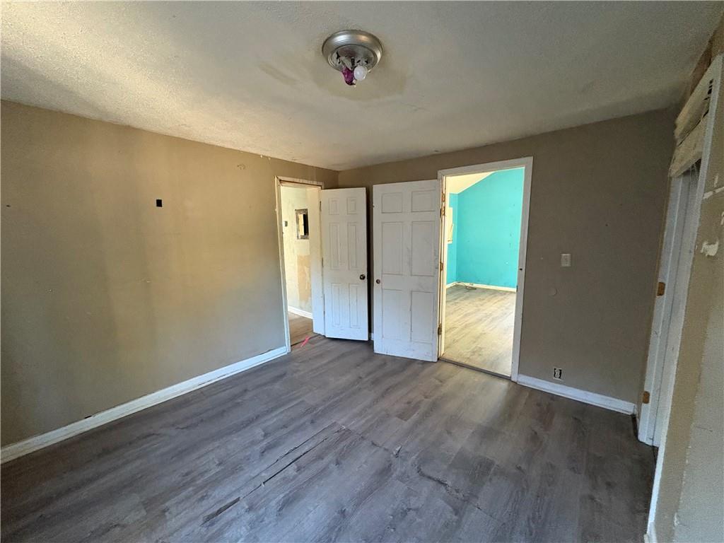 267 East Broad Street Newnan, GA 30263 - Photo 11 of 15 wooden floor in an empty room with a window