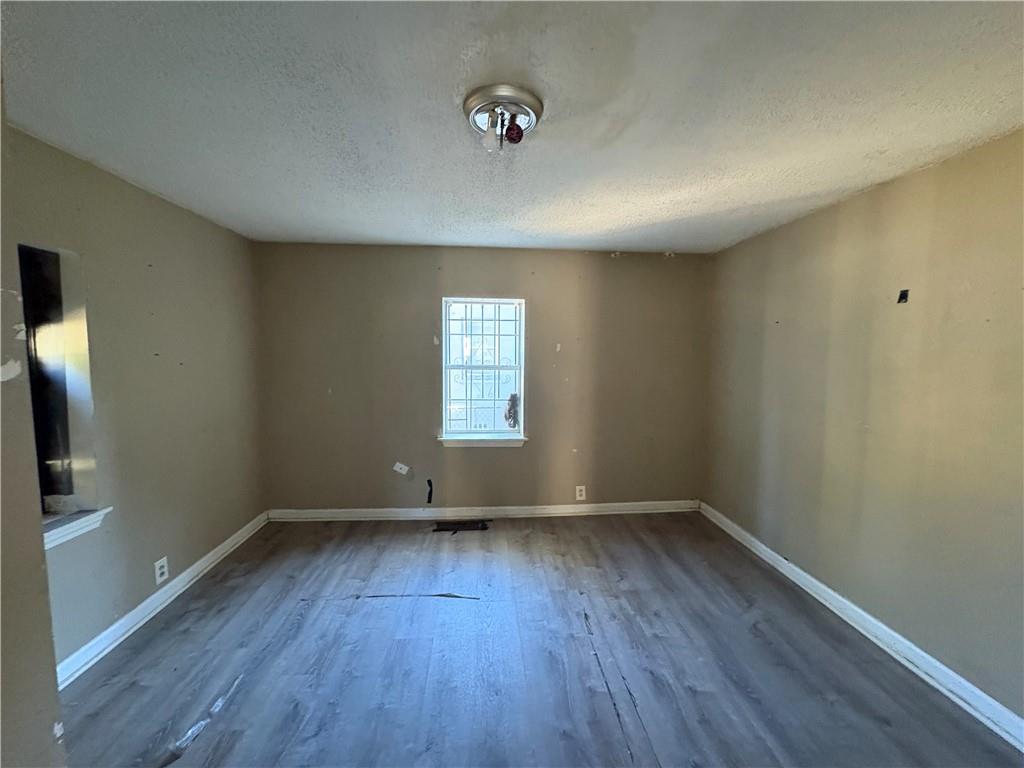 267 East Broad Street Newnan, GA 30263 - Photo 12 of 15 an empty room with wooden floor and windows