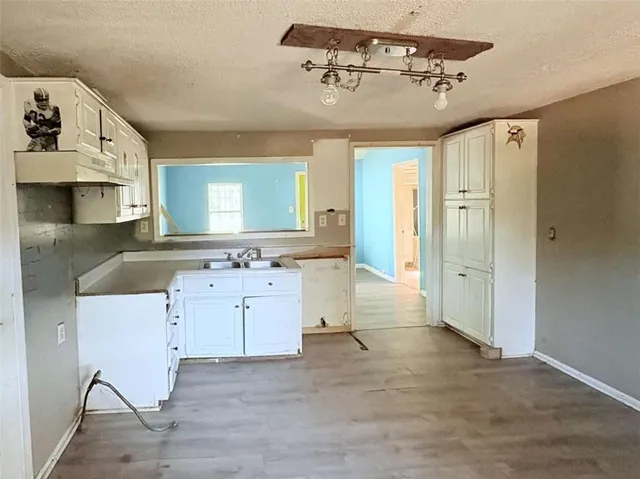 a spacious bathroom with a granite countertop sink mirror and vanity