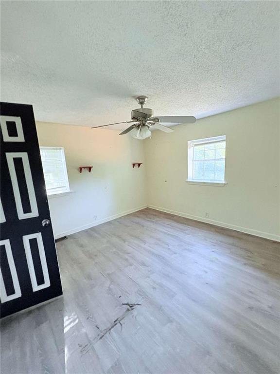 267 East Broad Street Newnan, GA 30263 - Photo 7 of 15 wooden floor in an empty room with a window