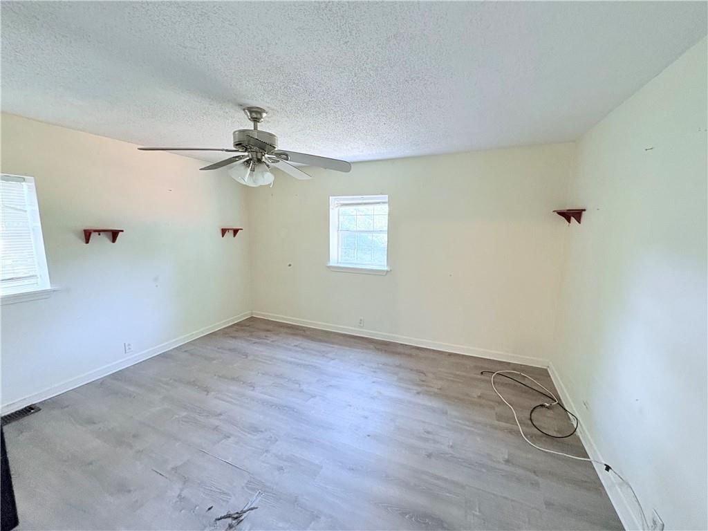 267 East Broad Street Newnan, GA 30263 - Photo 9 of 15 an empty room with a window and a fan