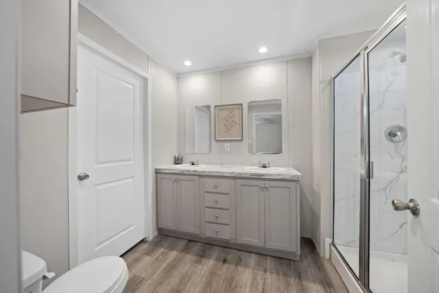 a bedroom with a bed and a flat tv screen on the dresser