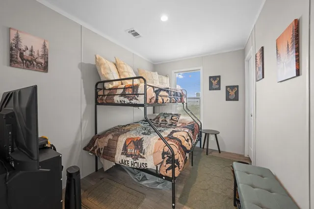 a bedroom with furniture and a flat screen tv