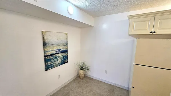 a view of a room that has a door and a white bed