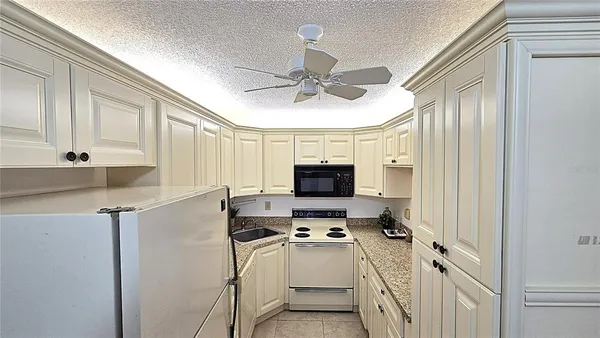 a kitchen with stainless steel appliances a stove microwave and a refrigerator
