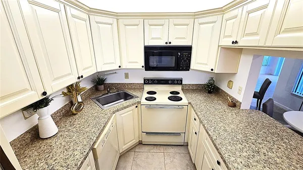 a kitchen with a stove a sink and a refrigerator