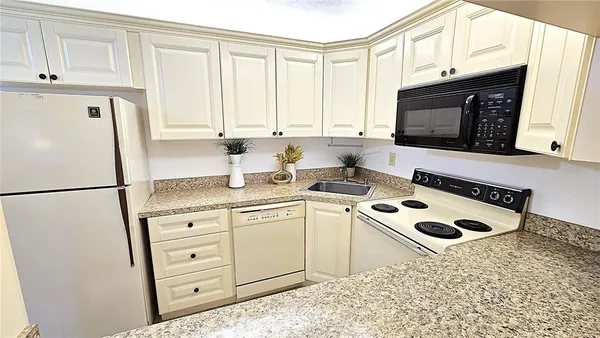 a kitchen with appliances cabinets and a sink