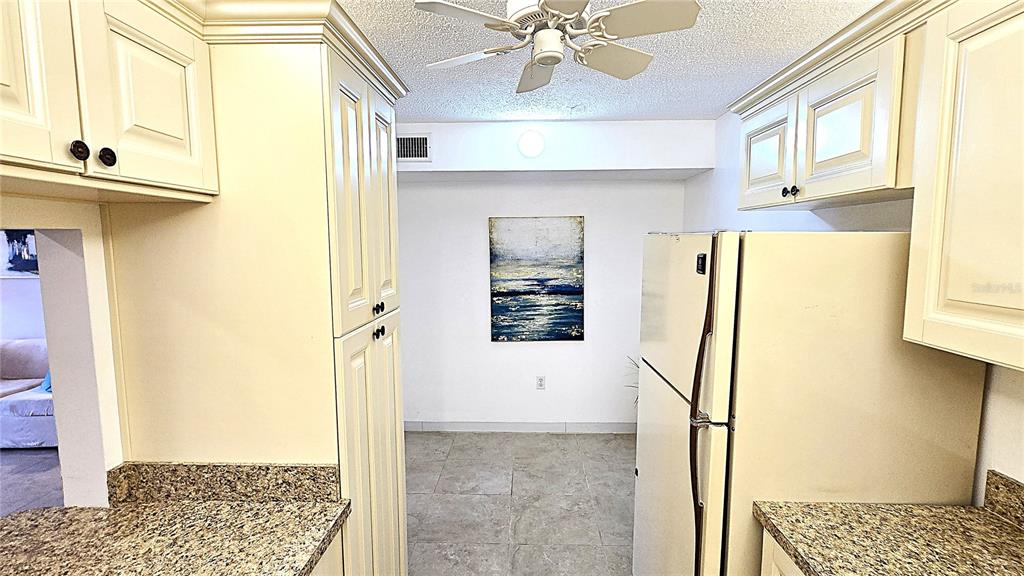 1109 Pine Ridge Circle West, Unit C1 Tarpon Springs, FL 34688 - Photo 21 of 50 a view of a hallway with windows and chandelier