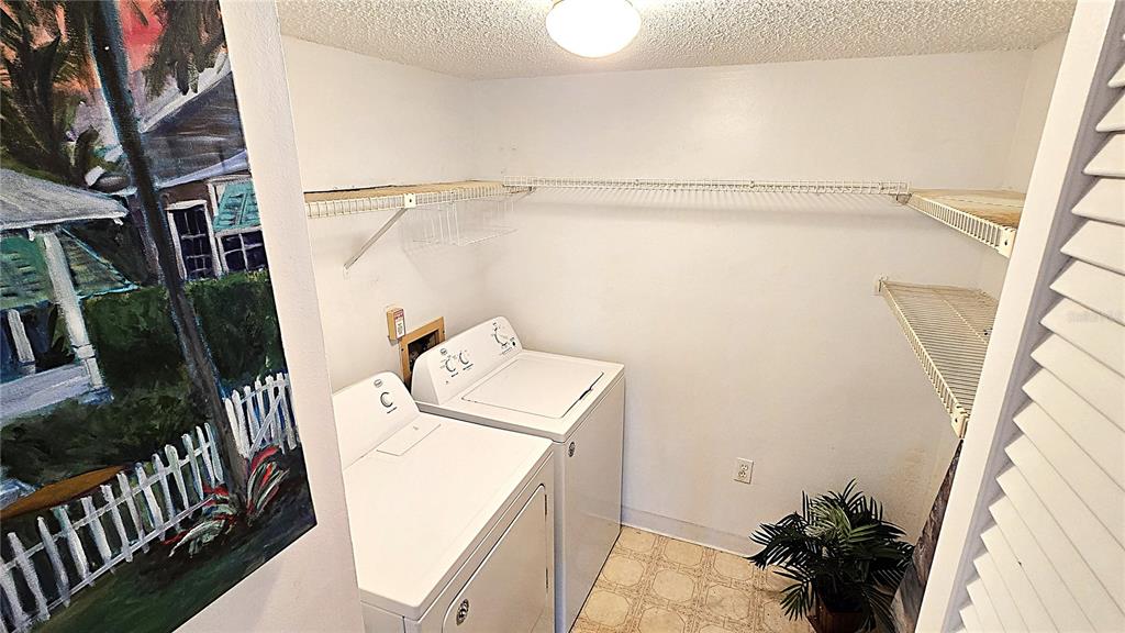 1109 Pine Ridge Circle West, Unit C1 Tarpon Springs, FL 34688 - Photo 24 of 50 a utility room with dryer and washer