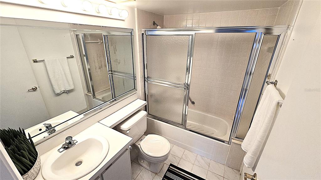 1109 Pine Ridge Circle West, Unit C1 Tarpon Springs, FL 34688 - Photo 32 of 50 a bathroom with a sink toilet and shower