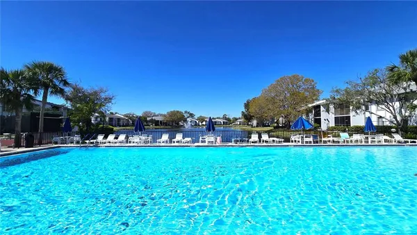 a view of a swimming pool and a yard