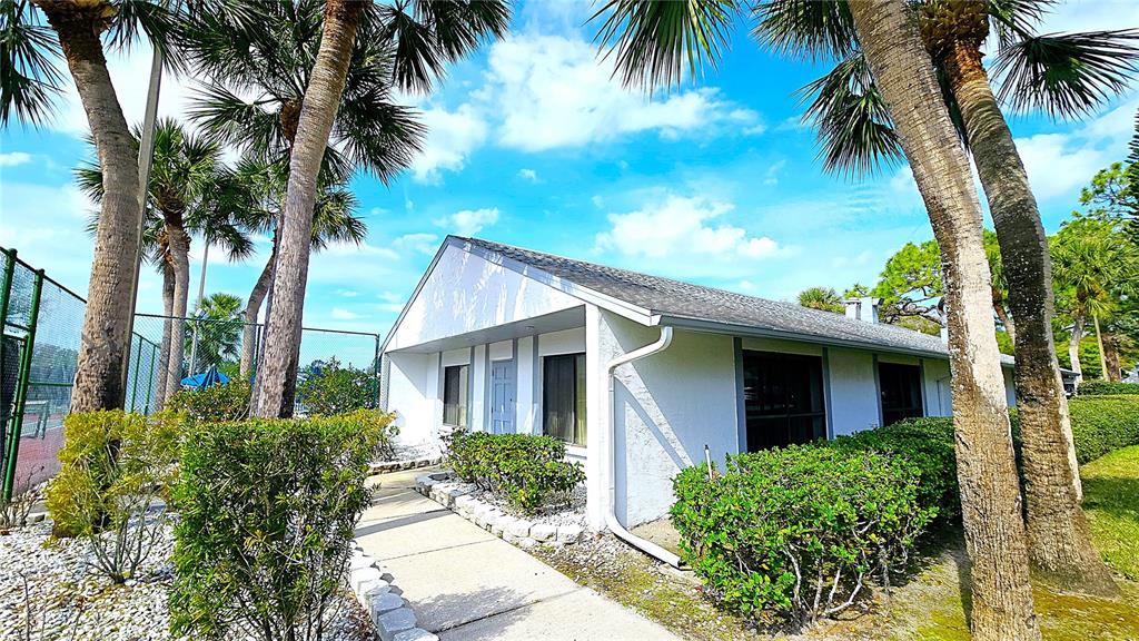 1109 Pine Ridge Circle West, Unit C1 Tarpon Springs, FL 34688 - Photo 42 of 50 a front view of house with yard and green space