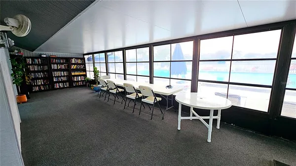 a dining room with furniture and a window