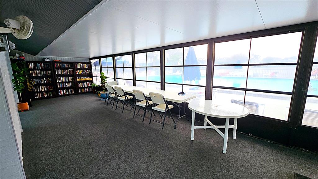 1109 Pine Ridge Circle West, Unit C1 Tarpon Springs, FL 34688 - Photo 48 of 50 a dining room with furniture and a window