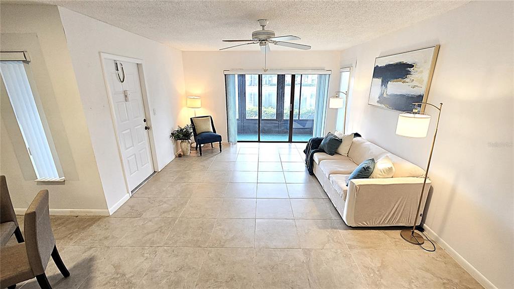 1109 Pine Ridge Circle West, Unit C1 Tarpon Springs, FL 34688 - Photo 9 of 50 a living room with furniture and a window