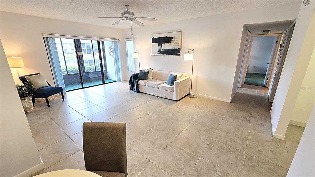 1109 Pine Ridge Circle West, Unit C1 Tarpon Springs, FL 34688 - Photo 10 of 50 a living room with furniture and a large window