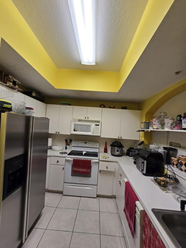 8930 West Flagler Street, Unit 221 Miami, FL 33174 - Photo 6 of 16 a kitchen with a sink a refrigerator and cabinets