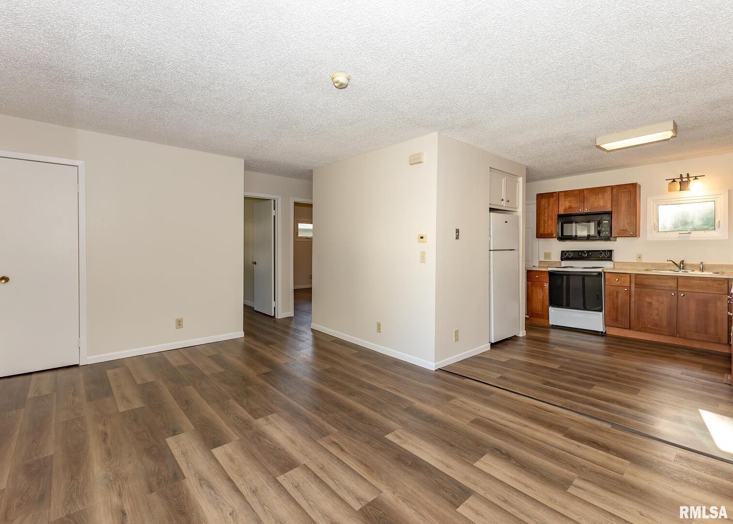 1529 North 8th Street Clinton, IA 52732 - Photo 5 of 15 a view of a kitchen with wooden floor and electronic appliances