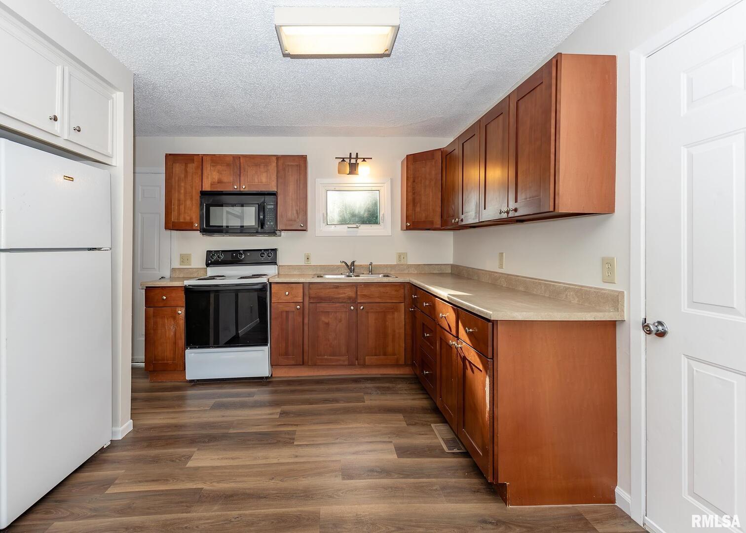 1529 North 8th Street Clinton, IA 52732 - Photo 6 of 15 a kitchen with stainless steel appliances granite countertop a stove a sink dishwasher and a refrigerator