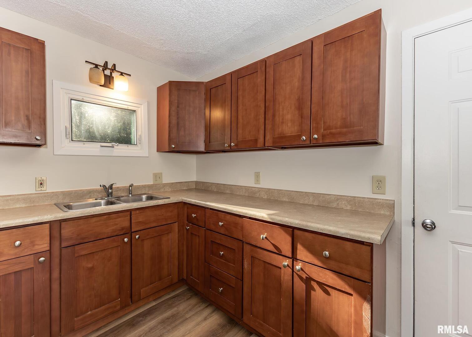 1529 North 8th Street Clinton, IA 52732 - Photo 7 of 15 a kitchen with sink cabinets and stainless steel appliances