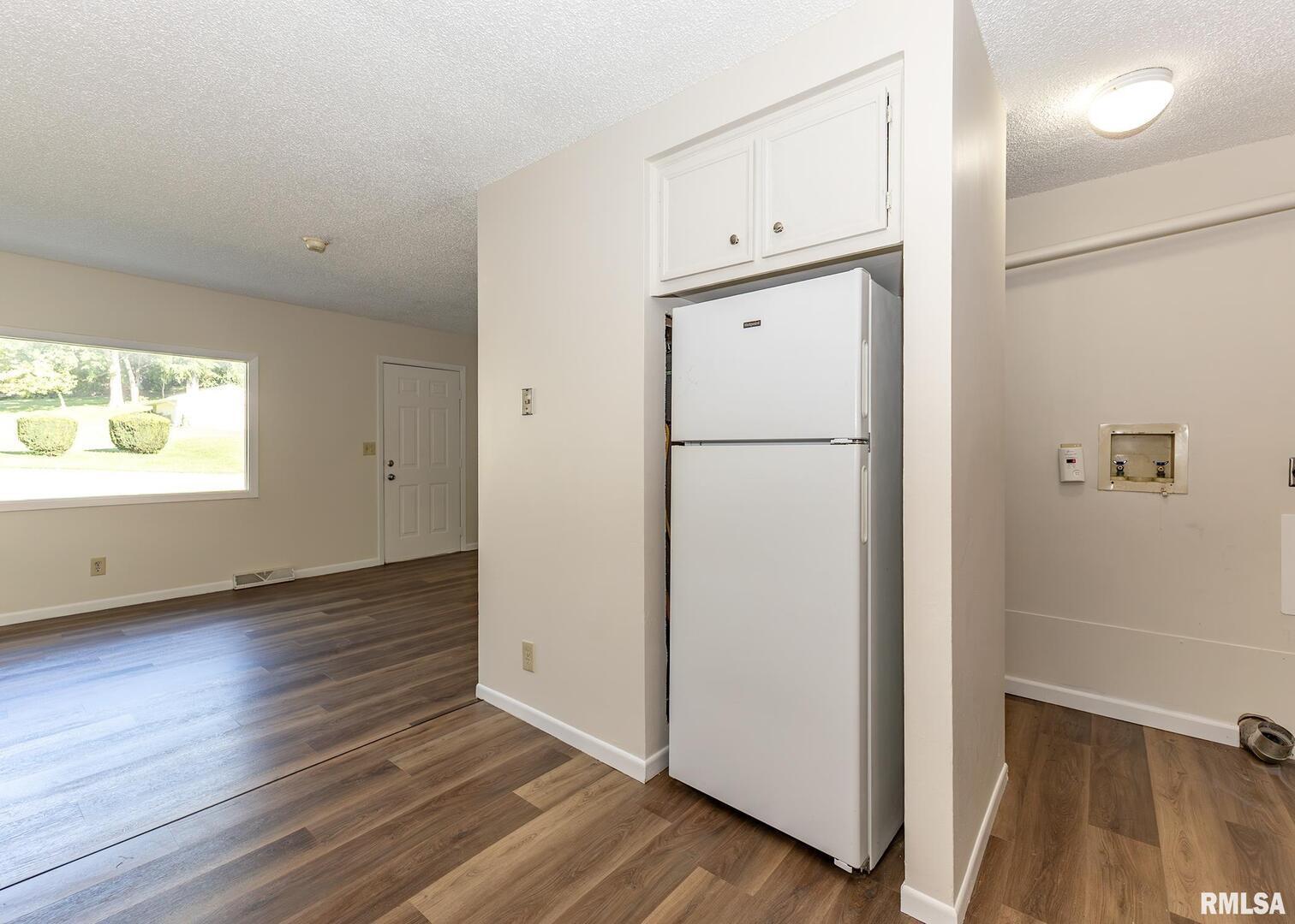 1529 North 8th Street Clinton, IA 52732 - Photo 8 of 15 a view of an empty room with wooden floor and a window