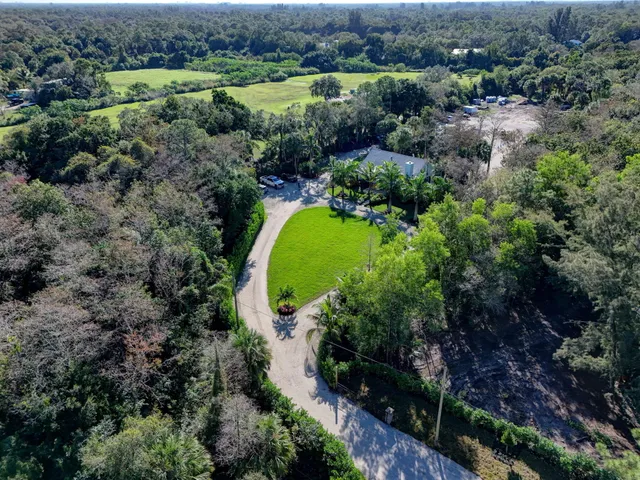 an aerial view of a house with a swimming pool