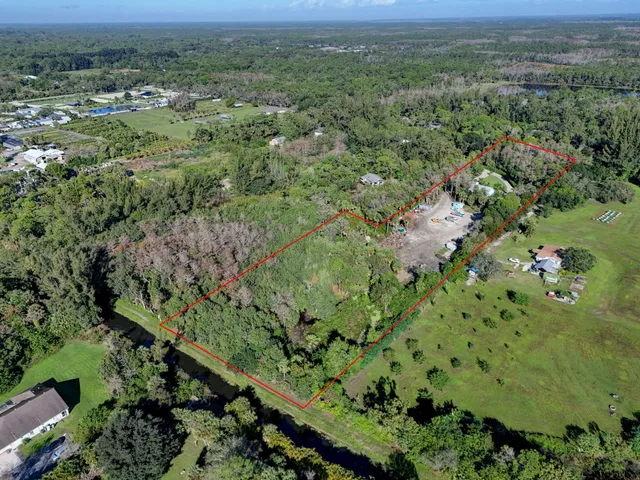 an aerial view of a houses with a yard