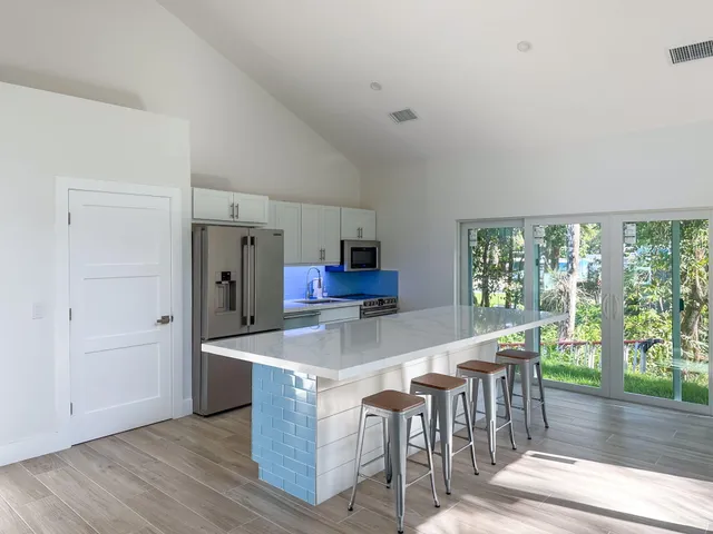 a kitchen with kitchen island a sink table and chairs