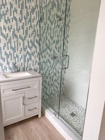 a bathroom with a shower and a sink