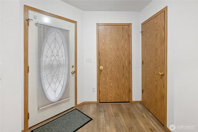 a view of front door with wooden floor