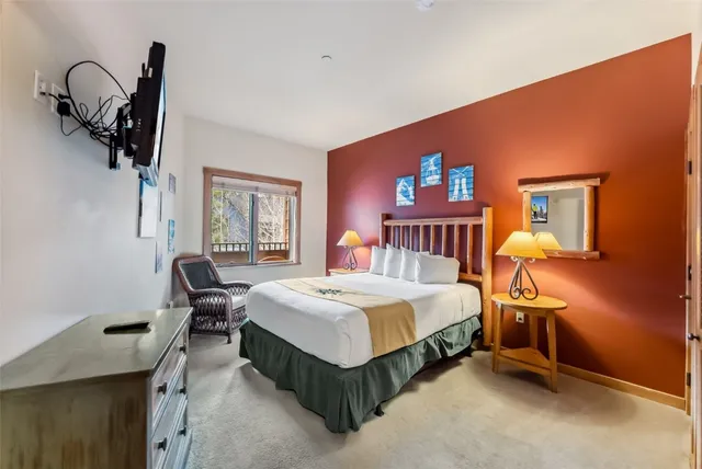 a bedroom with a bed and dresser